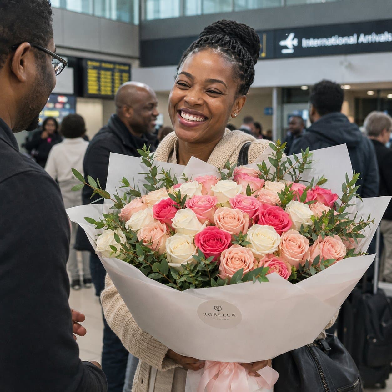 A customer welcomed at the airport with a large pink Rosella bouquet
