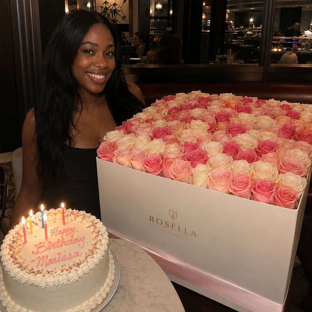 A birthday celebration with a large pink Rosella rose arrangement