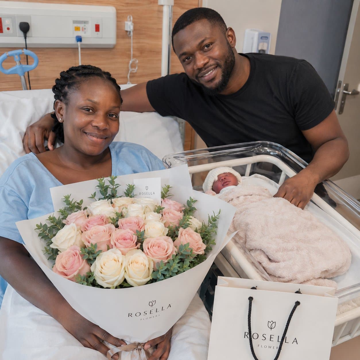 New parents celebrating with a soft pink and white Rosella rose bouquet