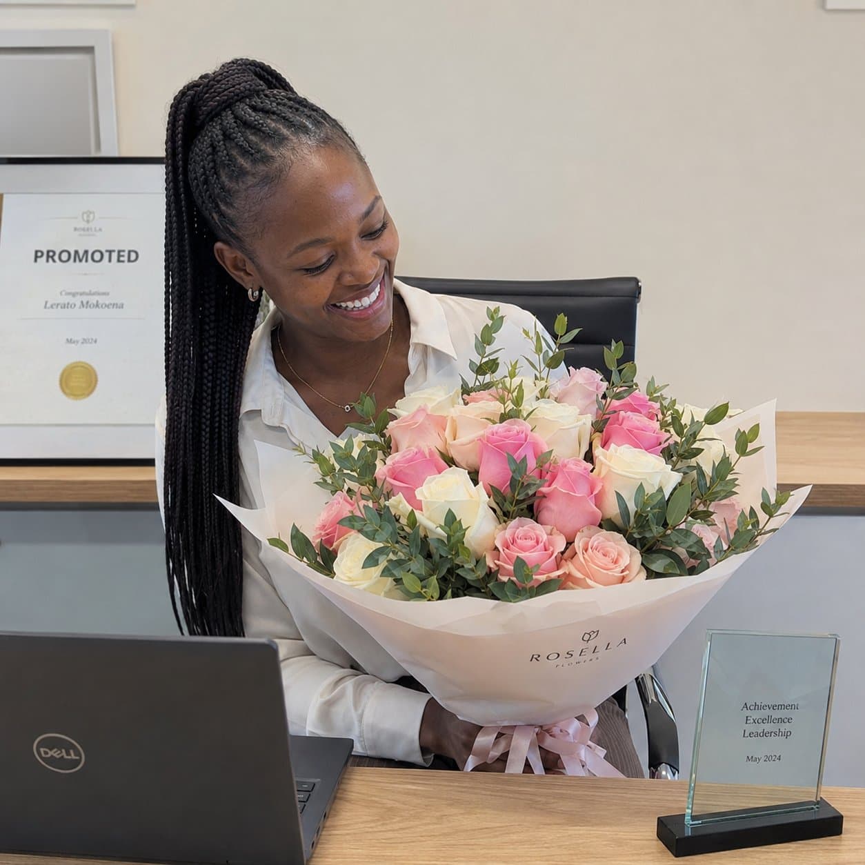 A professional celebrating a promotion with a Rosella bouquet
